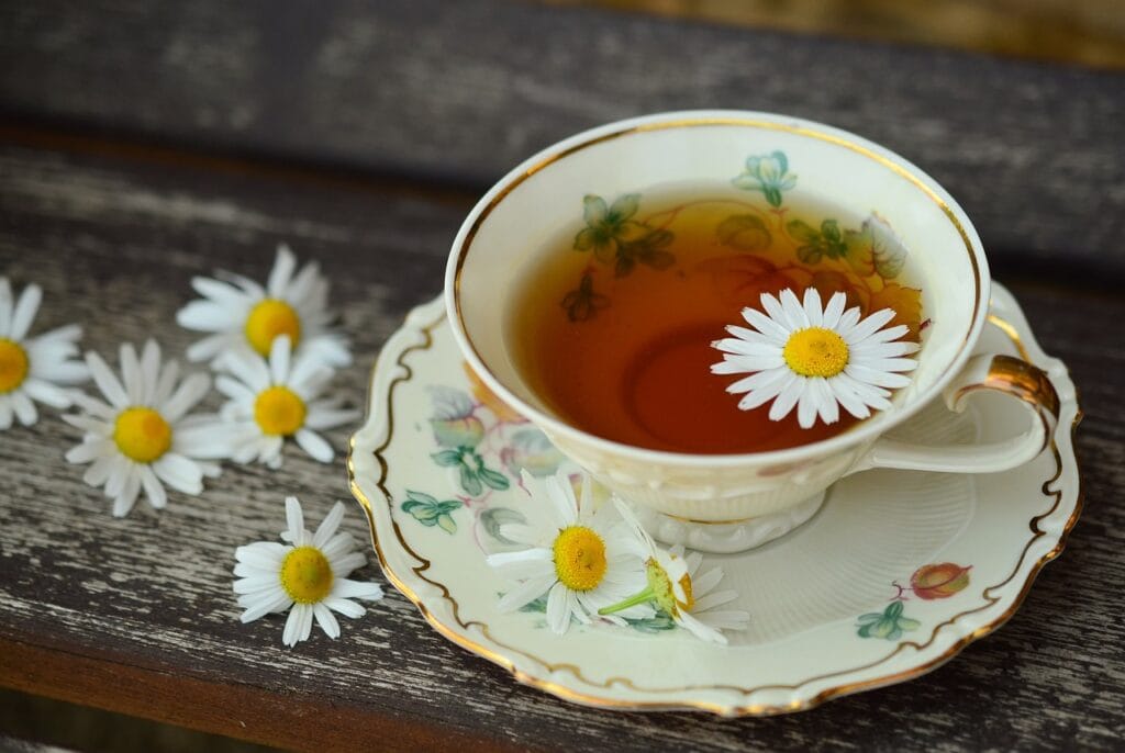 a cup of tea with flowers on a saucer