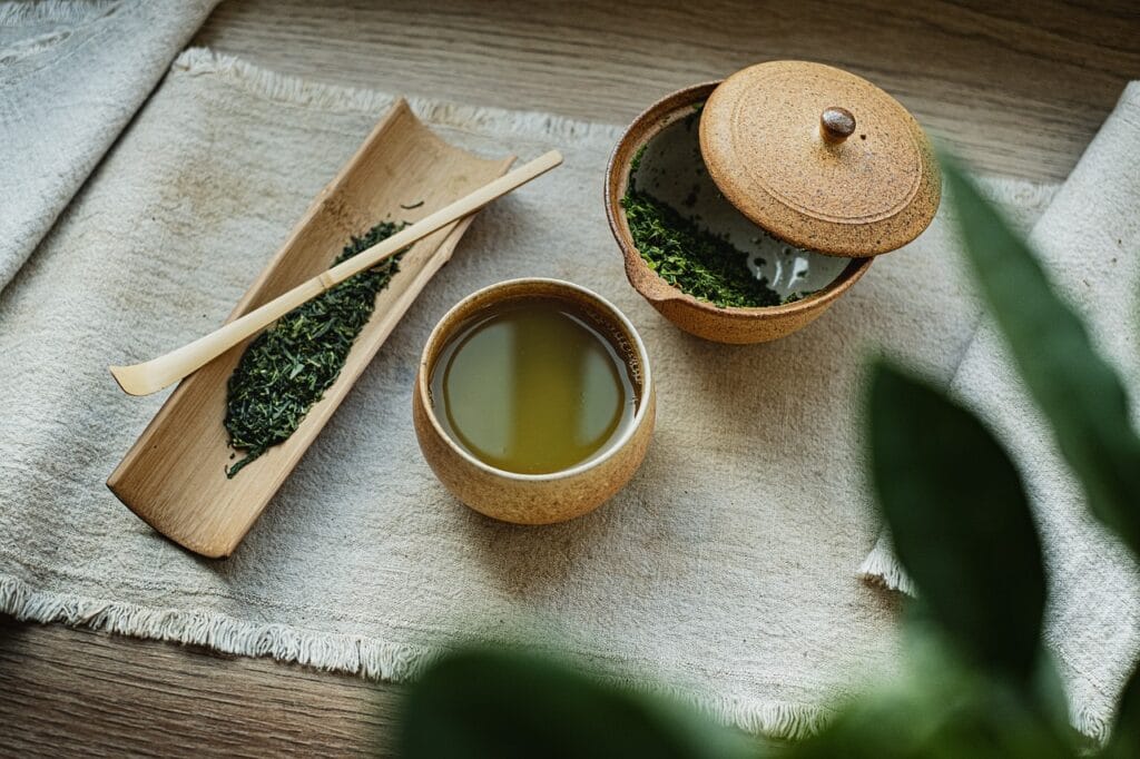 a bowl of green tea with a lid and a bowl of liquid